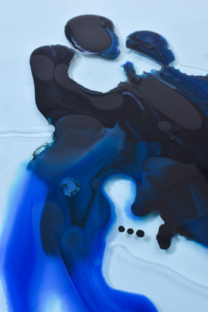 Aaron Dalton - Drops of blue liquid floating in water