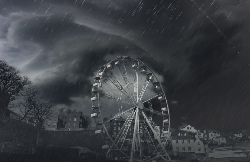 Elinor Grimmer - Dark image of a ferris wheel in a storm.